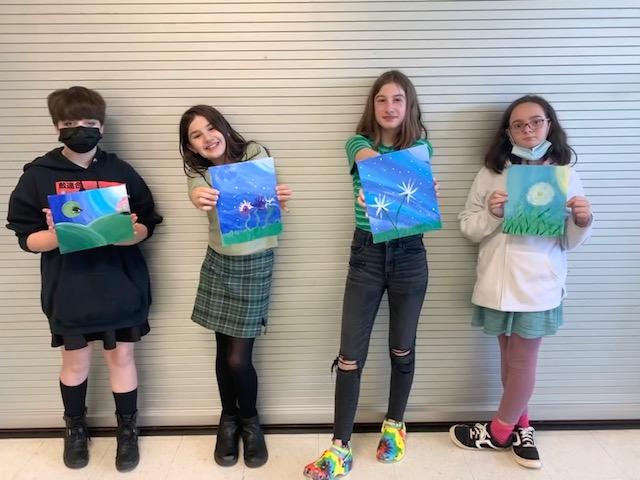 Fifth-graders Lilly Graber, Evelyn Hartman, Clare Wilson, and Madaileine Irdi display their finished artwork