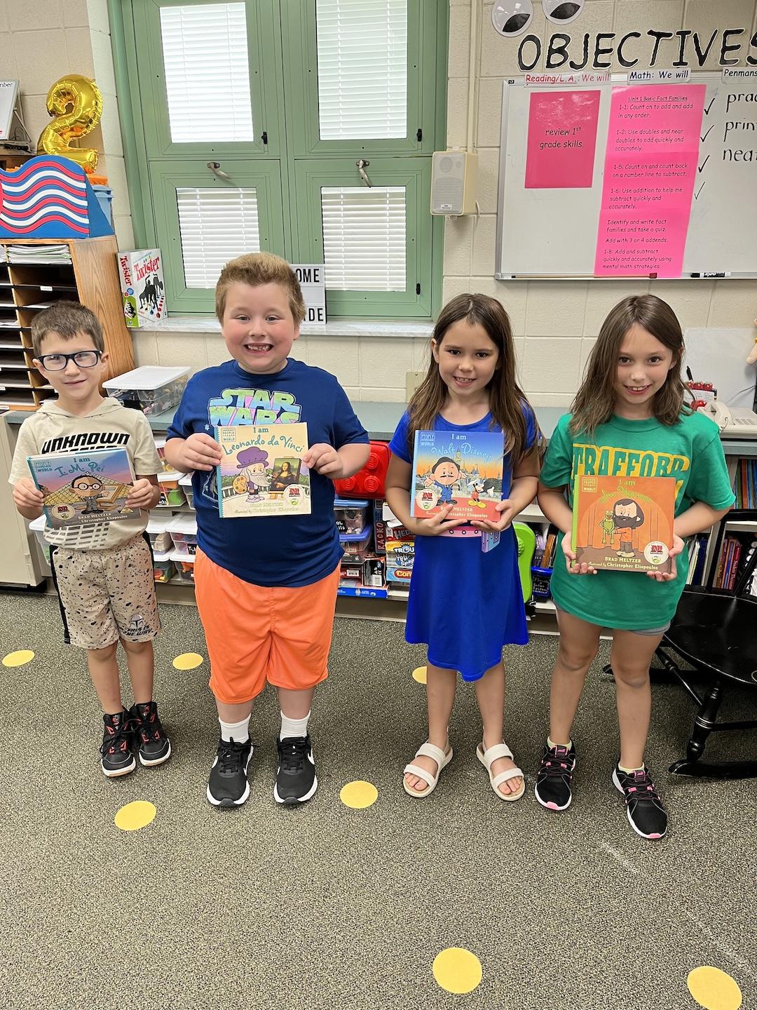 Corbin Weston, Judson Binkley, Ava Reilly, and Leilani Pape display some of the new books