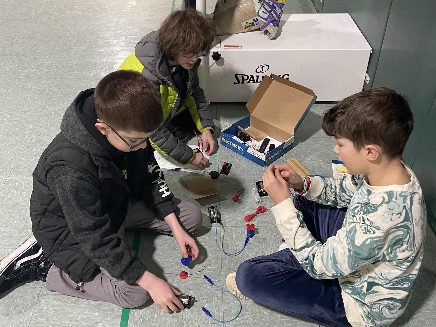5th-graders Joseph Raithel, Cruz Castaneda, and Jack Fry explore connecting circuits to create electricity