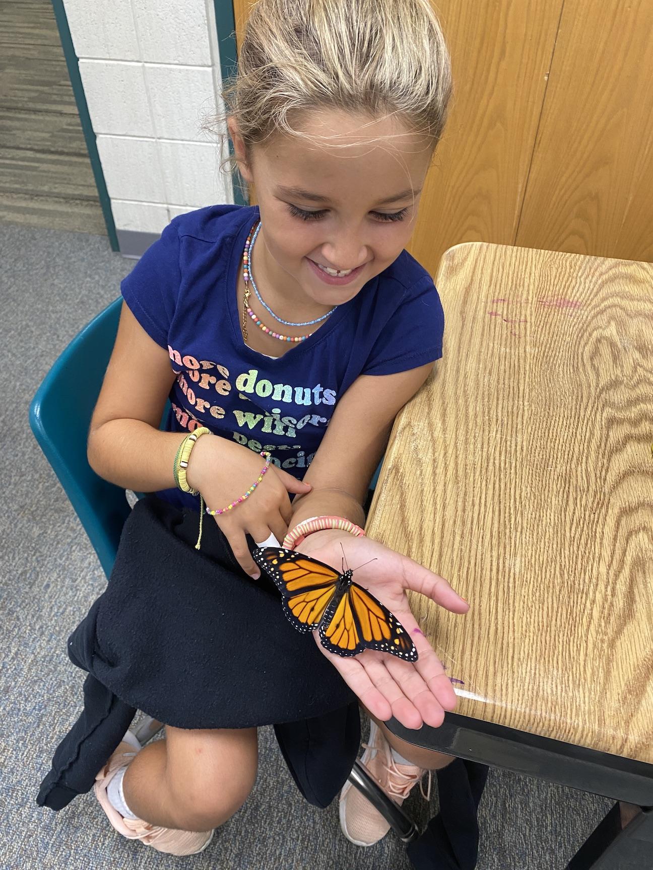 Kara Tranter holds a butterfly