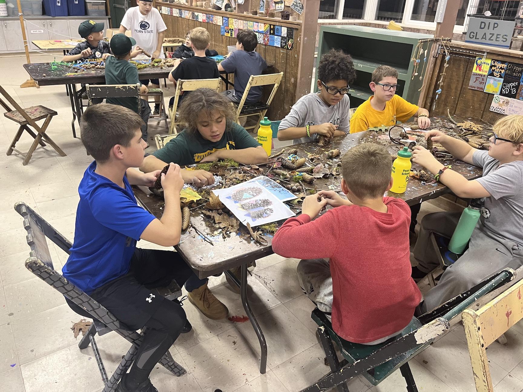 Trafford 5th-graders Jackson Botti, Josh Keefer, Cooper Bost, TJ Neel, James Hudson, and Xavier Wade use natural materials to build their creature creation